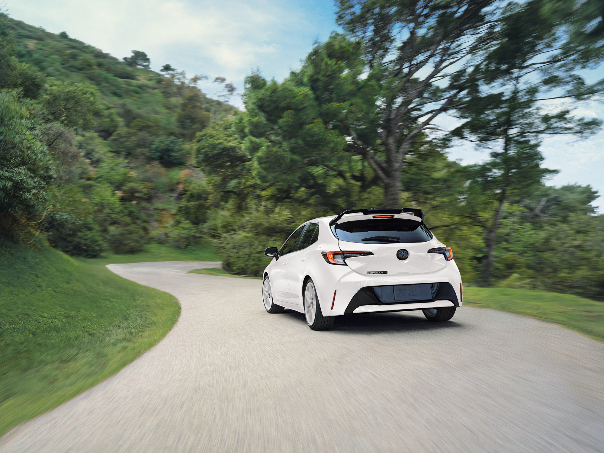 2026 Toyota Corolla Hatchback rear of car in white driving away