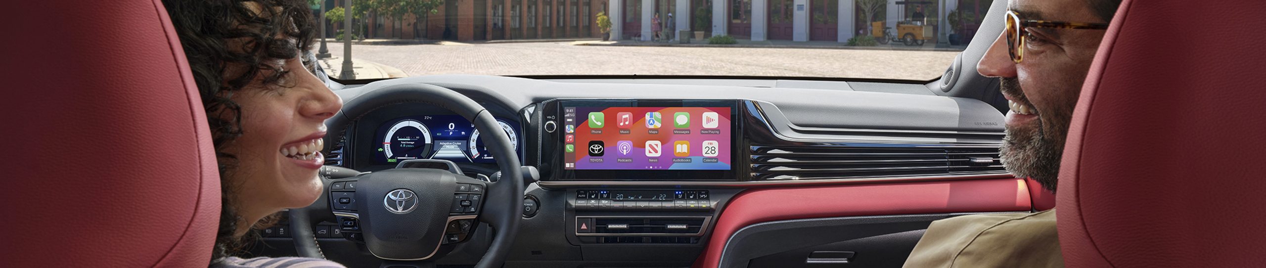 happy couple driving toyota